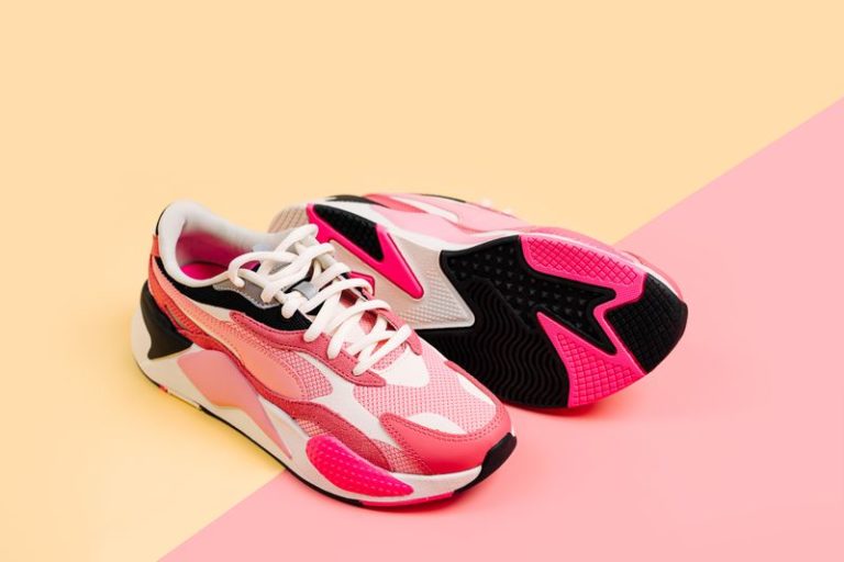 Bright female sneakers on pink background. Fashion blog or magazine concept. Women's shoes, trendy sneakers, fashion, style, lifestyle