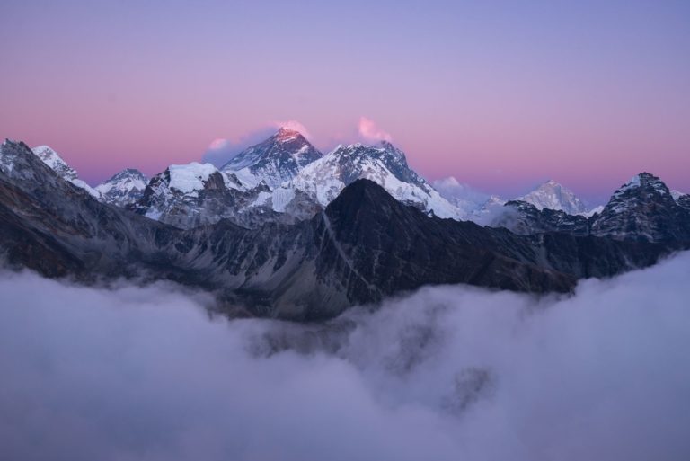 Beautiful scenery of the summit of Mount Everest covered with snow under the white clouds