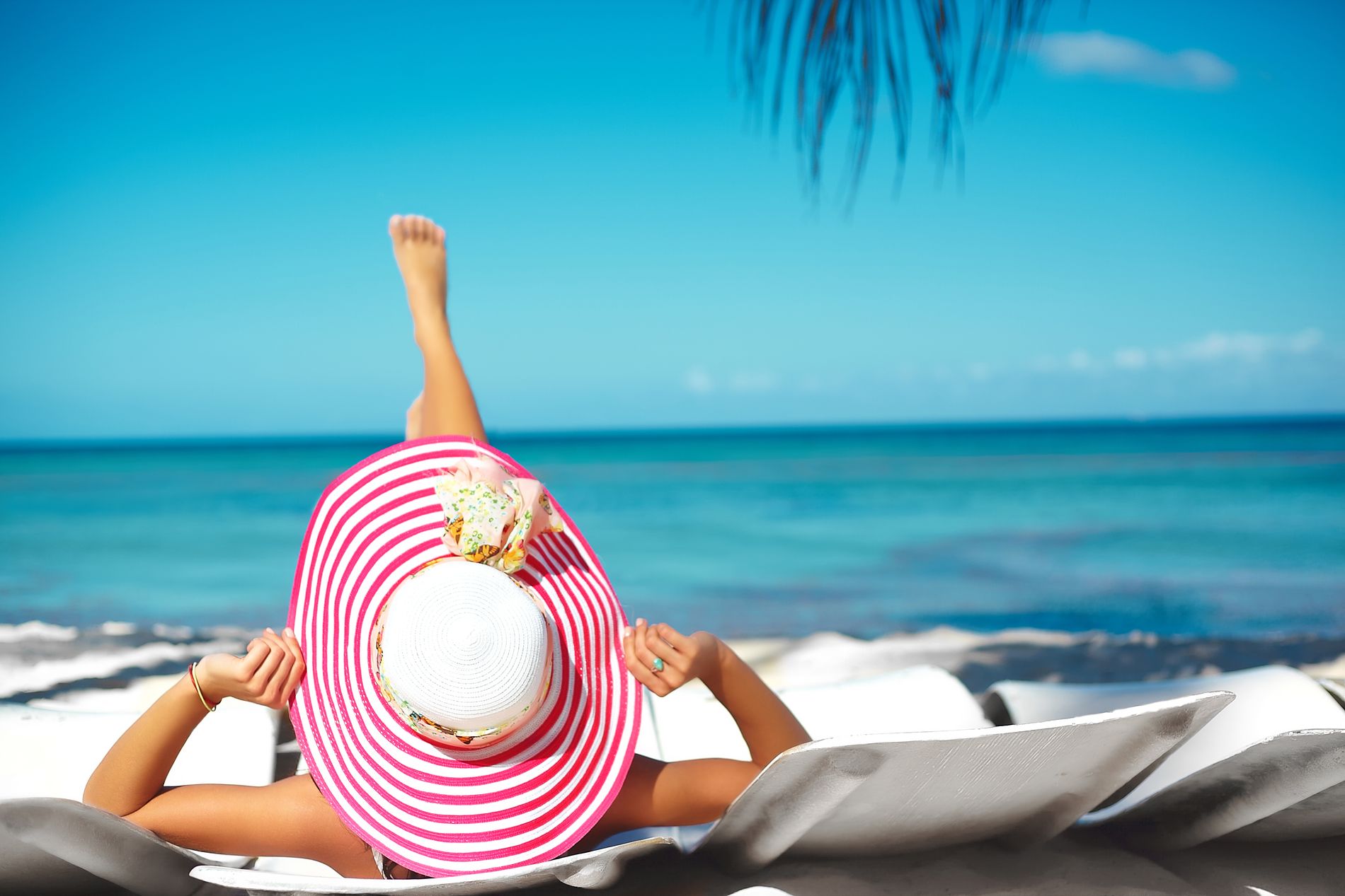 beautiful-woman-model-sunbathing-beach-chair-white-bikini-colorful-sunhat-blue-summer-water-ocean_result