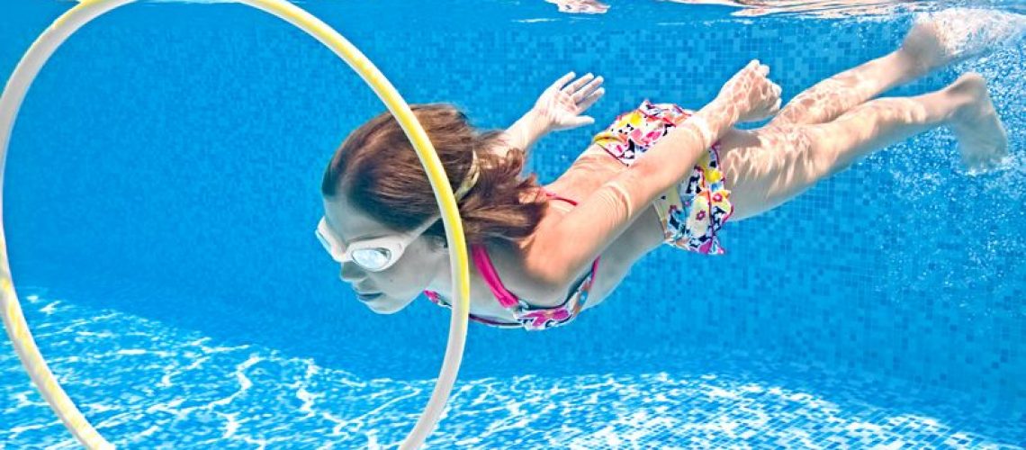 child-swims-underwater-swimming-pool-little-active-girl-dives-has-fun-water
